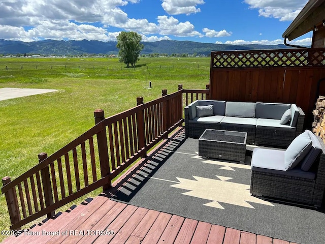 wooden deck with a rural view, a mountain view, and an outdoor hangout area