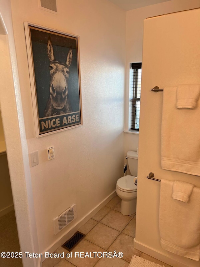 bathroom with tile patterned floors and toilet