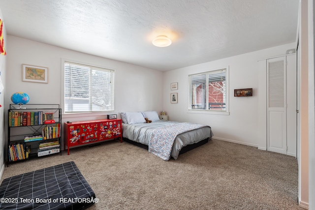 bedroom featuring a textured ceiling and carpet flooring