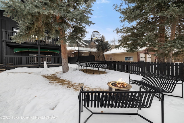 exterior space with a trampoline and a fire pit