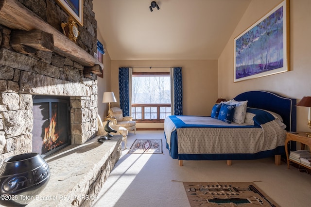 bedroom with lofted ceiling, carpet floors, and a fireplace