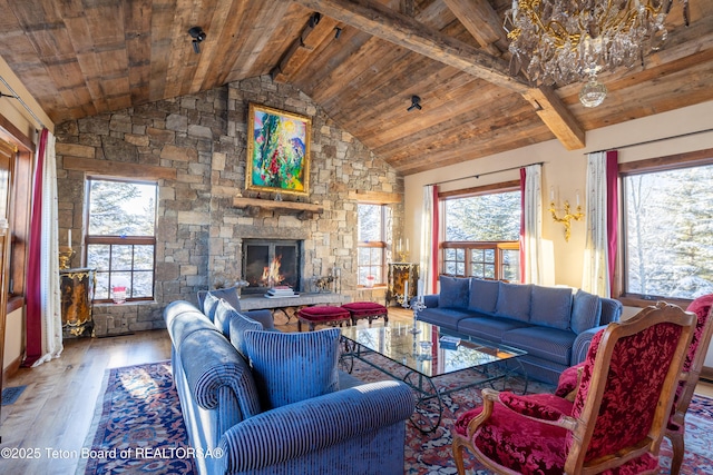 living room featuring hardwood / wood-style floors, a fireplace, vaulted ceiling with beams, plenty of natural light, and wooden ceiling