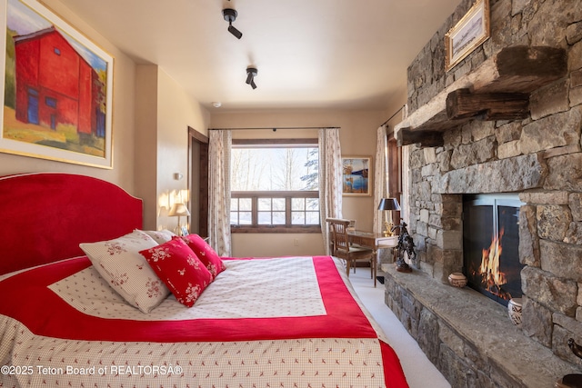 carpeted bedroom with a fireplace