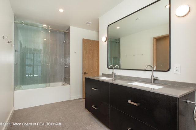 bathroom with enclosed tub / shower combo, tile patterned floors, and vanity