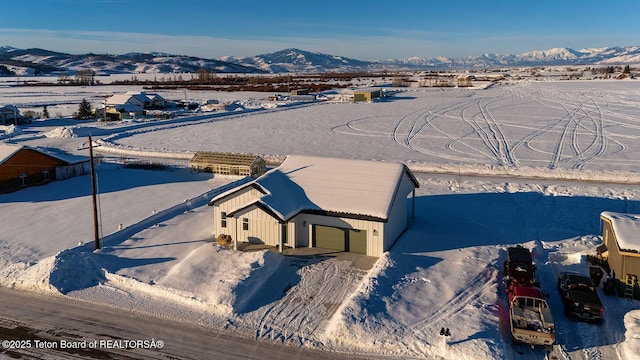 snowy aerial view with a mountain view