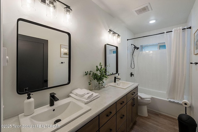 full bathroom with vanity, hardwood / wood-style floors, shower / tub combo with curtain, and toilet