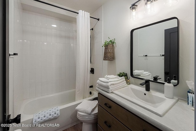 full bathroom featuring shower / tub combo with curtain, vanity, and toilet