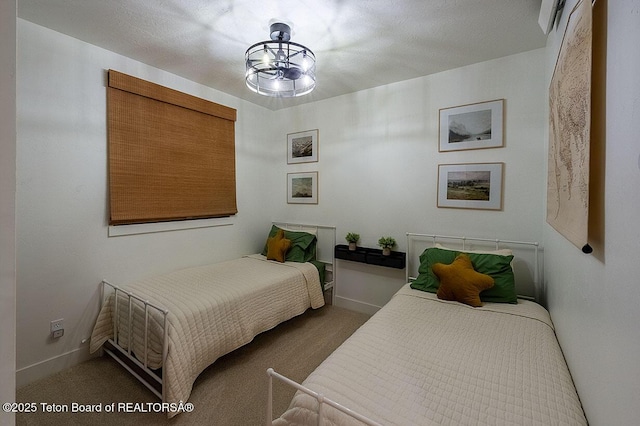 bedroom with an inviting chandelier and carpet