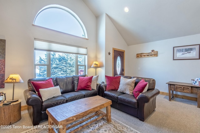 carpeted living room featuring high vaulted ceiling