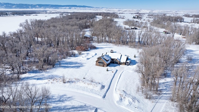 snowy aerial view with a mountain view