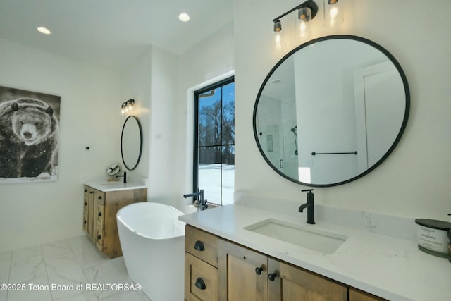 bathroom with vanity and independent shower and bath