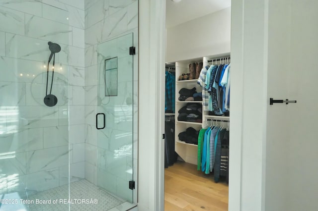 bathroom with walk in shower and hardwood / wood-style flooring