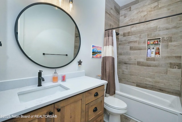 full bathroom with shower / tub combo with curtain, vanity, and toilet