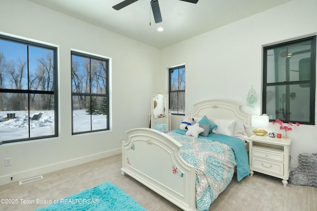 bedroom featuring ceiling fan and light carpet