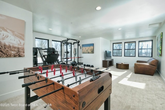 game room with a healthy amount of sunlight and light colored carpet