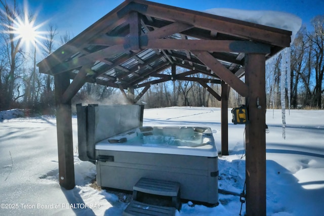 snow covered patio with a hot tub