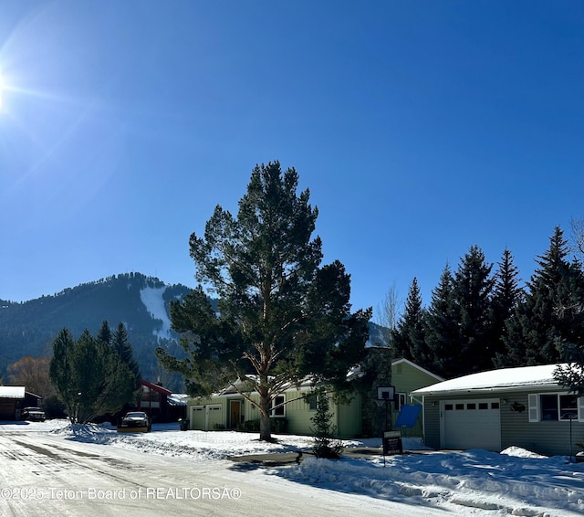 exterior space featuring a garage and a mountain view