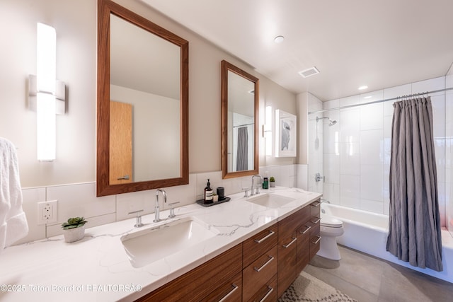 full bathroom featuring vanity, tile patterned floors, toilet, and shower / bath combo