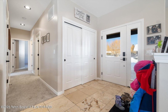 entrance foyer featuring light carpet