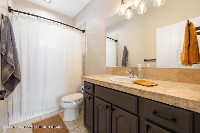 bathroom featuring vanity, tile patterned floors, and toilet