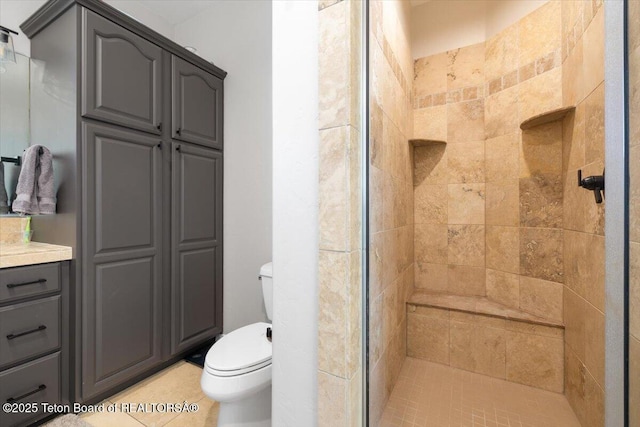 bathroom featuring toilet and a tile shower