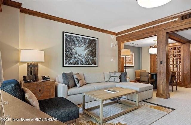 living room with crown molding and carpet