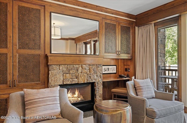 sitting room featuring wooden walls and a fireplace