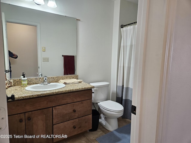 bathroom with walk in shower, tile patterned floors, vanity, and toilet