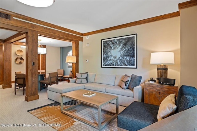 carpeted living room featuring ornamental molding