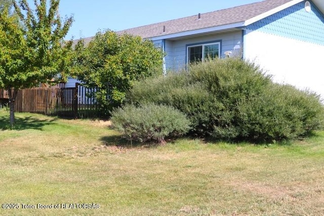 view of side of property with a lawn