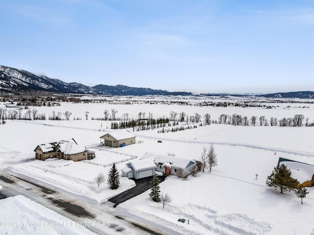 snowy aerial view with a mountain view