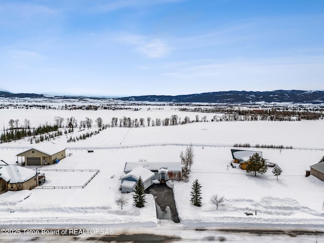 snowy aerial view featuring a mountain view