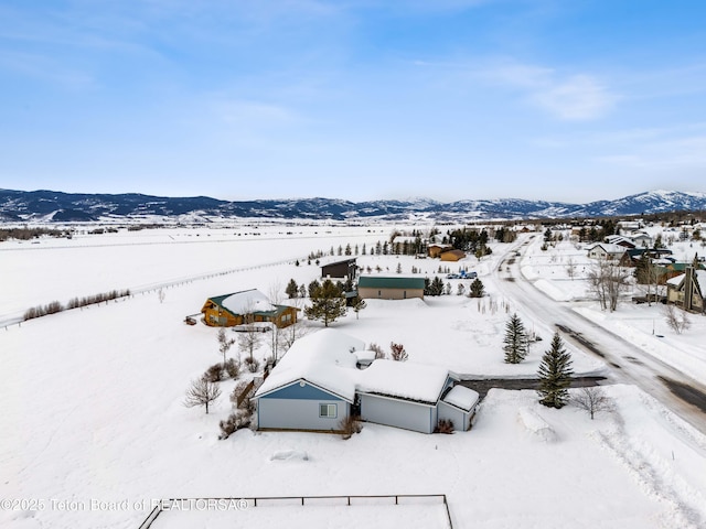 snowy aerial view featuring a mountain view