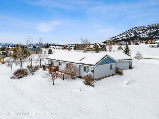 snow covered property featuring a mountain view