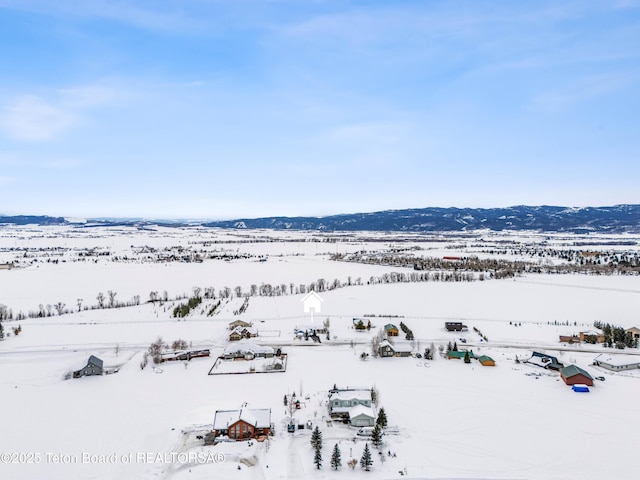 snowy aerial view with a mountain view