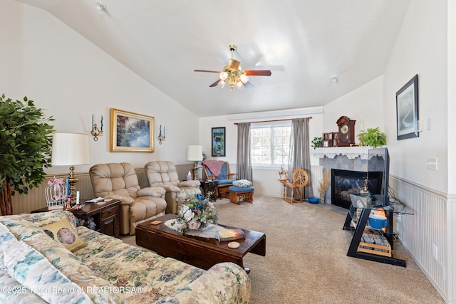 living room with light carpet, a fireplace, vaulted ceiling, and ceiling fan