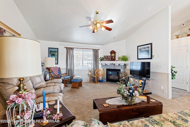 living room featuring lofted ceiling, light colored carpet, a fireplace, and ceiling fan