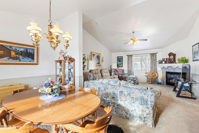 dining room featuring lofted ceiling, ceiling fan with notable chandelier, and carpet