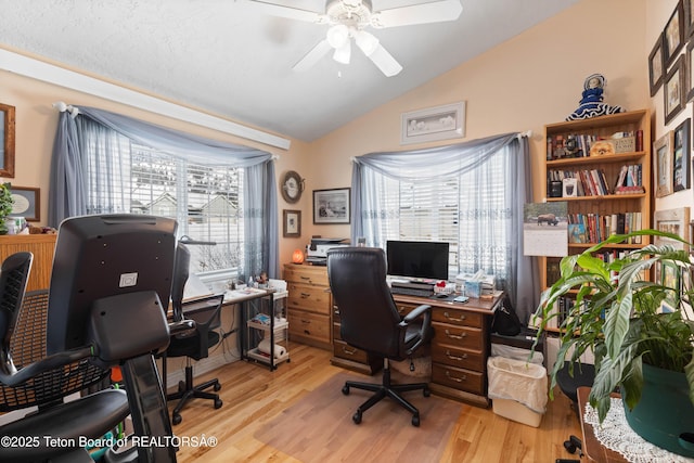 office area with vaulted ceiling, ceiling fan, and light wood-type flooring