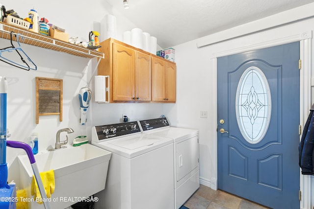 laundry area with cabinets, sink, and independent washer and dryer