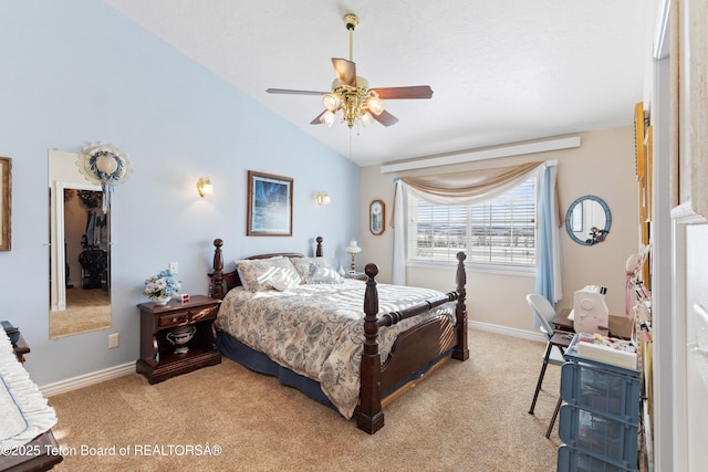 carpeted bedroom with lofted ceiling, a spacious closet, and ceiling fan