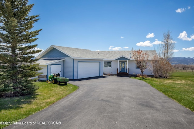 692 Cedar Creek Dr, Star Valley Ranch, WY 83127 - ranch-style house featuring an attached garage, a front yard, and driveway