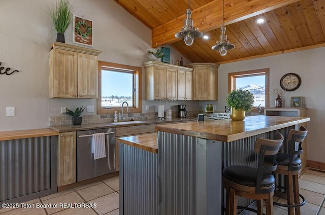 kitchen with butcher block counters, hanging light fixtures, stainless steel dishwasher, and a center island