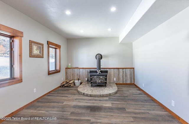 interior details with wood-type flooring and a wood stove