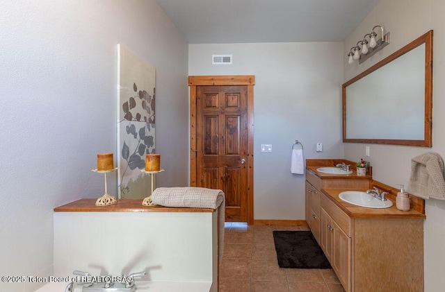 bathroom with tile patterned flooring and vanity