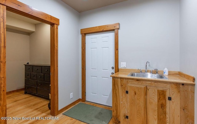 interior space with hardwood / wood-style flooring and sink