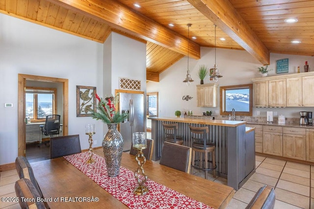 dining space with light tile patterned floors, beam ceiling, high vaulted ceiling, and wooden ceiling