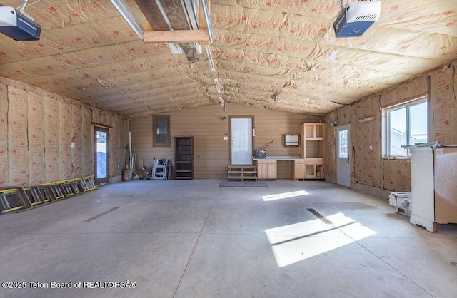 misc room featuring concrete flooring and vaulted ceiling