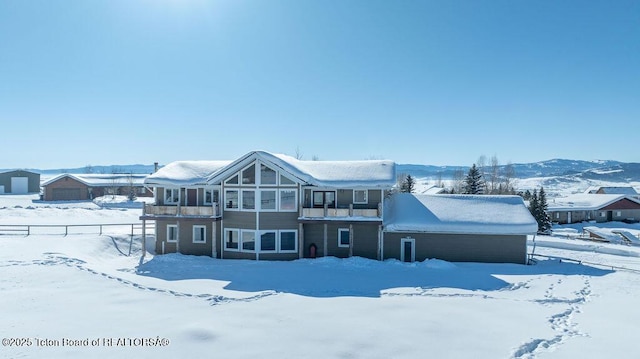 snow covered property featuring a mountain view