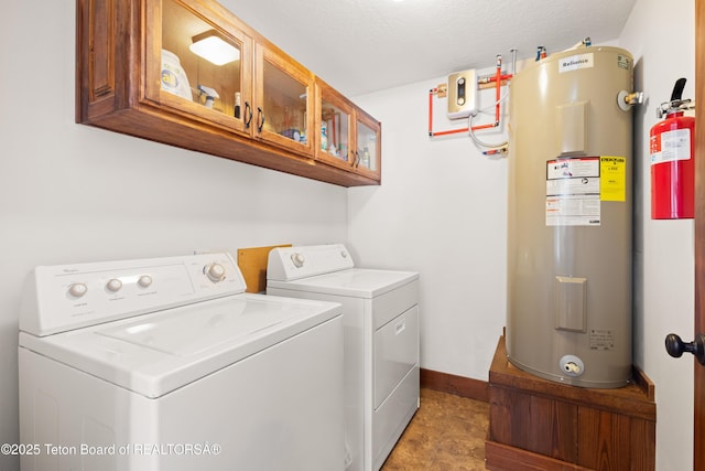 laundry area featuring cabinets, washer and clothes dryer, and electric water heater